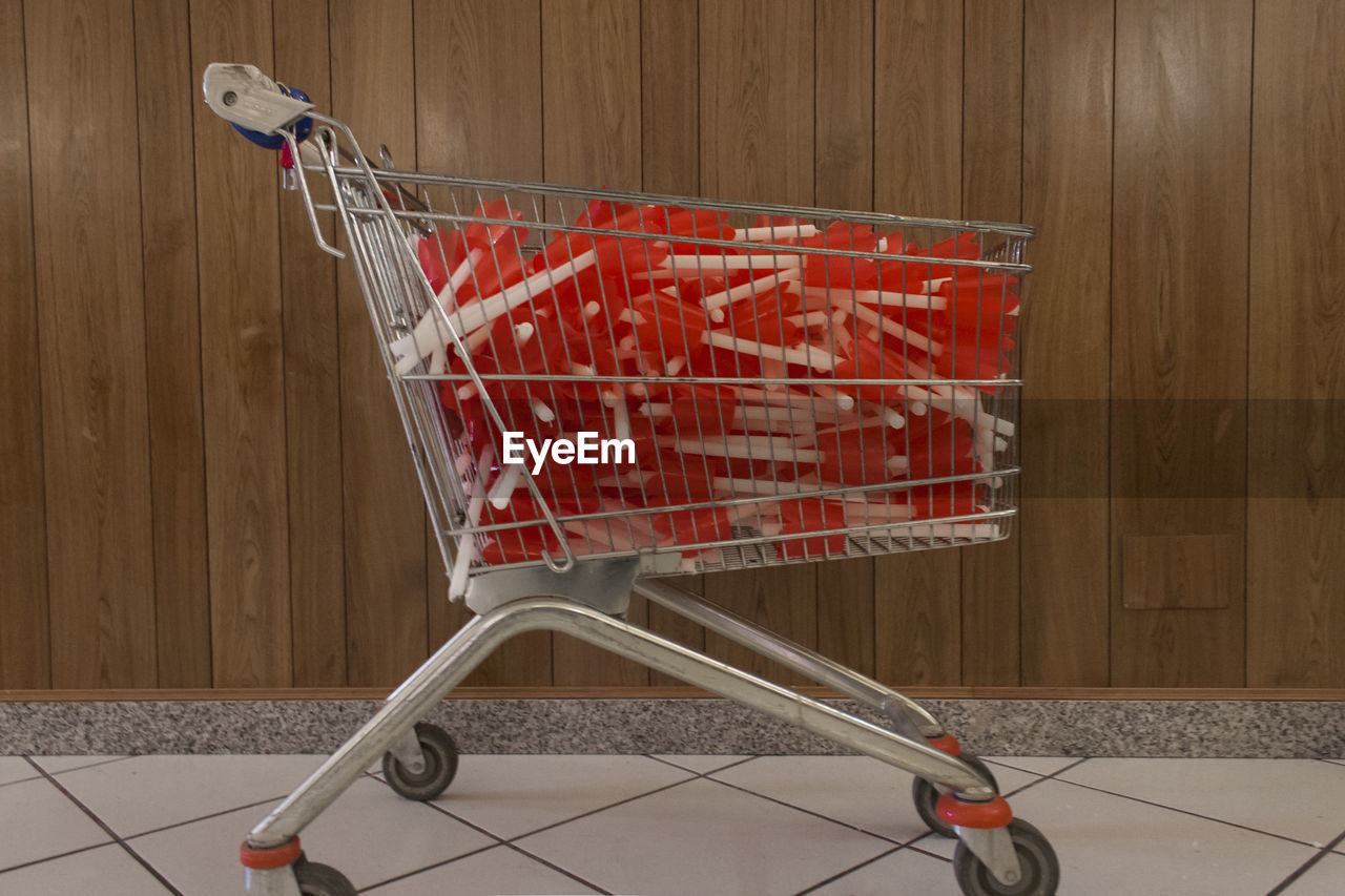 View of shopping cart full of red and white objects