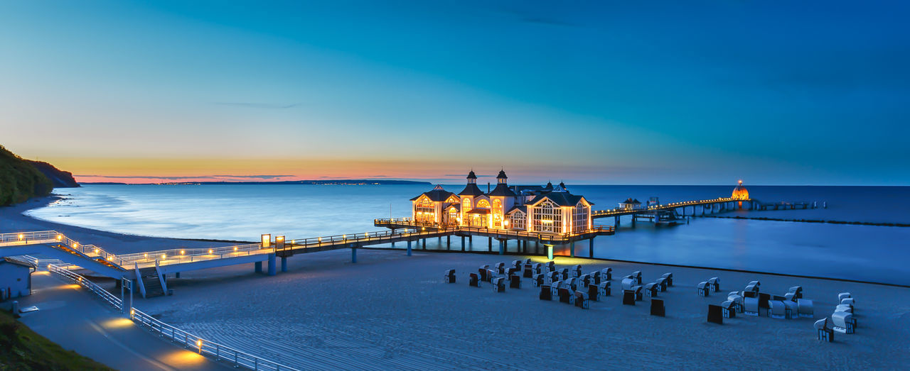 Modern enlightened pontoon on the beach and see