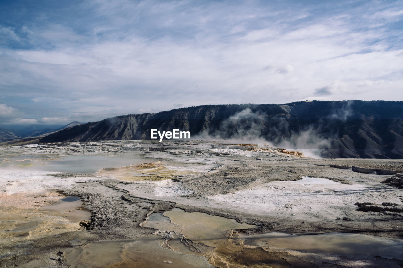 Idyllic shot of hot spring landscape against sky at yellowstone national park
