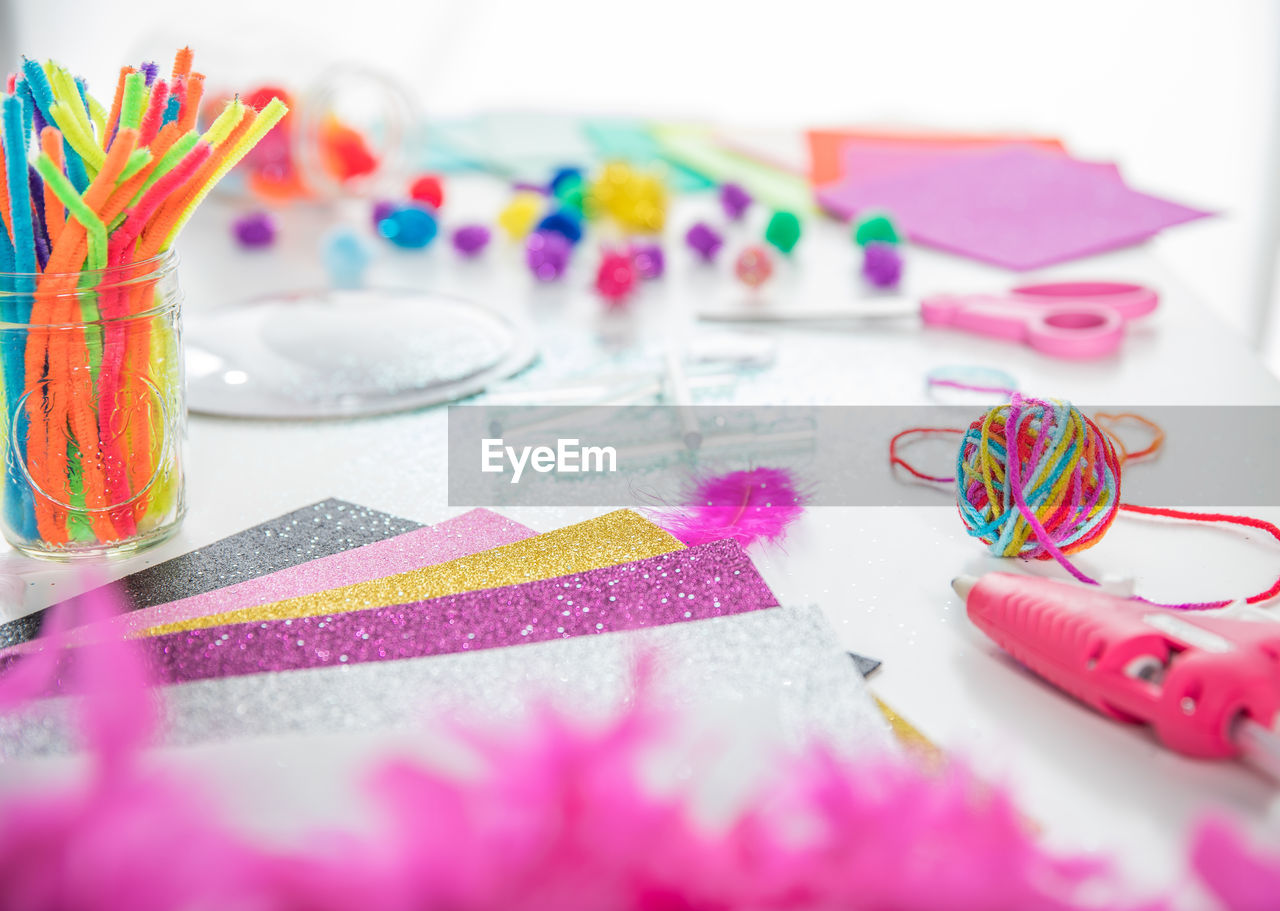 HIGH ANGLE VIEW OF MULTI COLORED ART ON TABLE