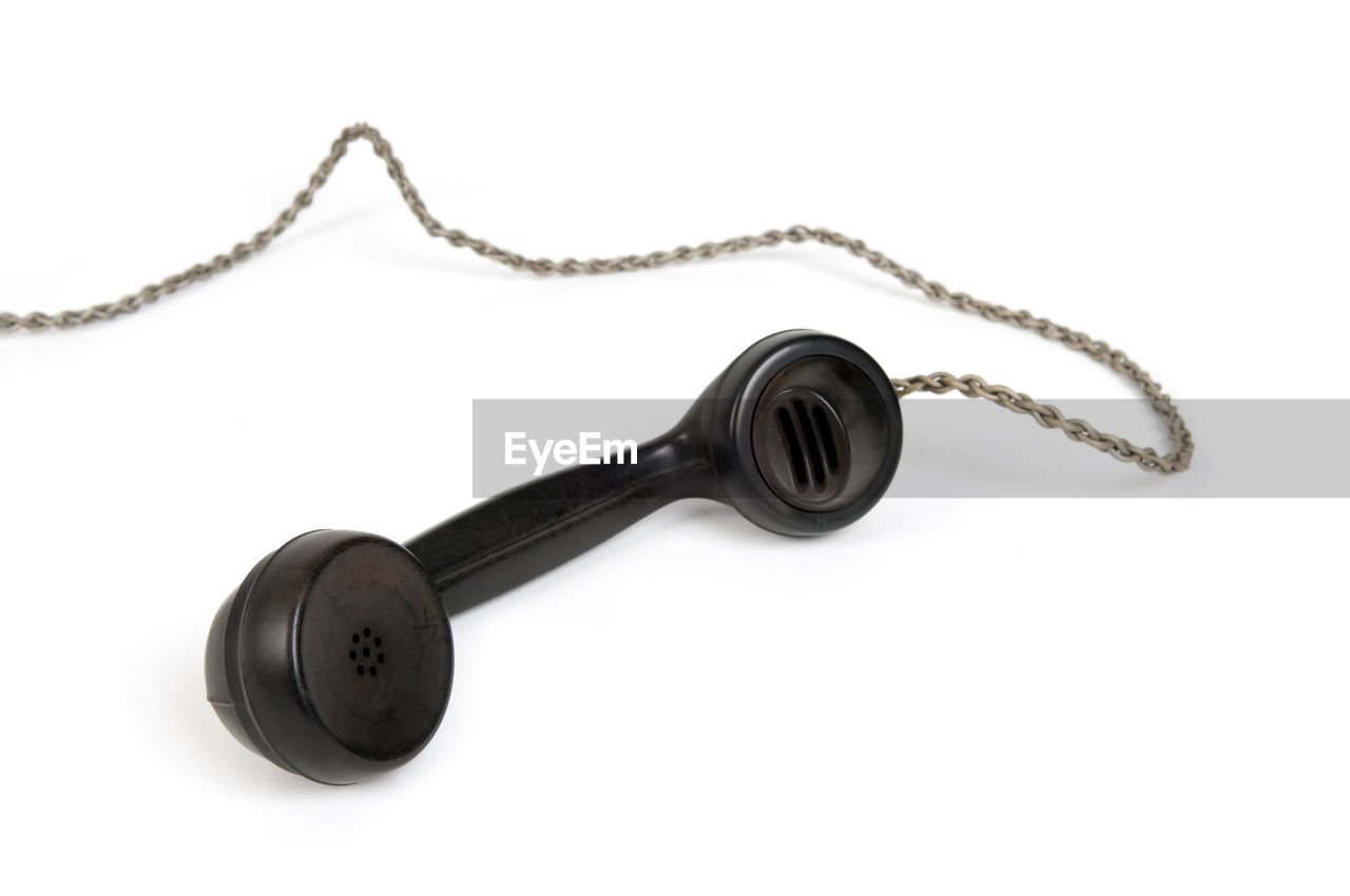 Close-up of telephone over white background