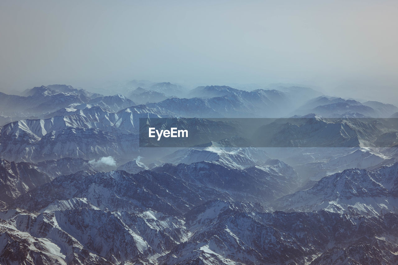 high angle view of snowcapped mountains against sky