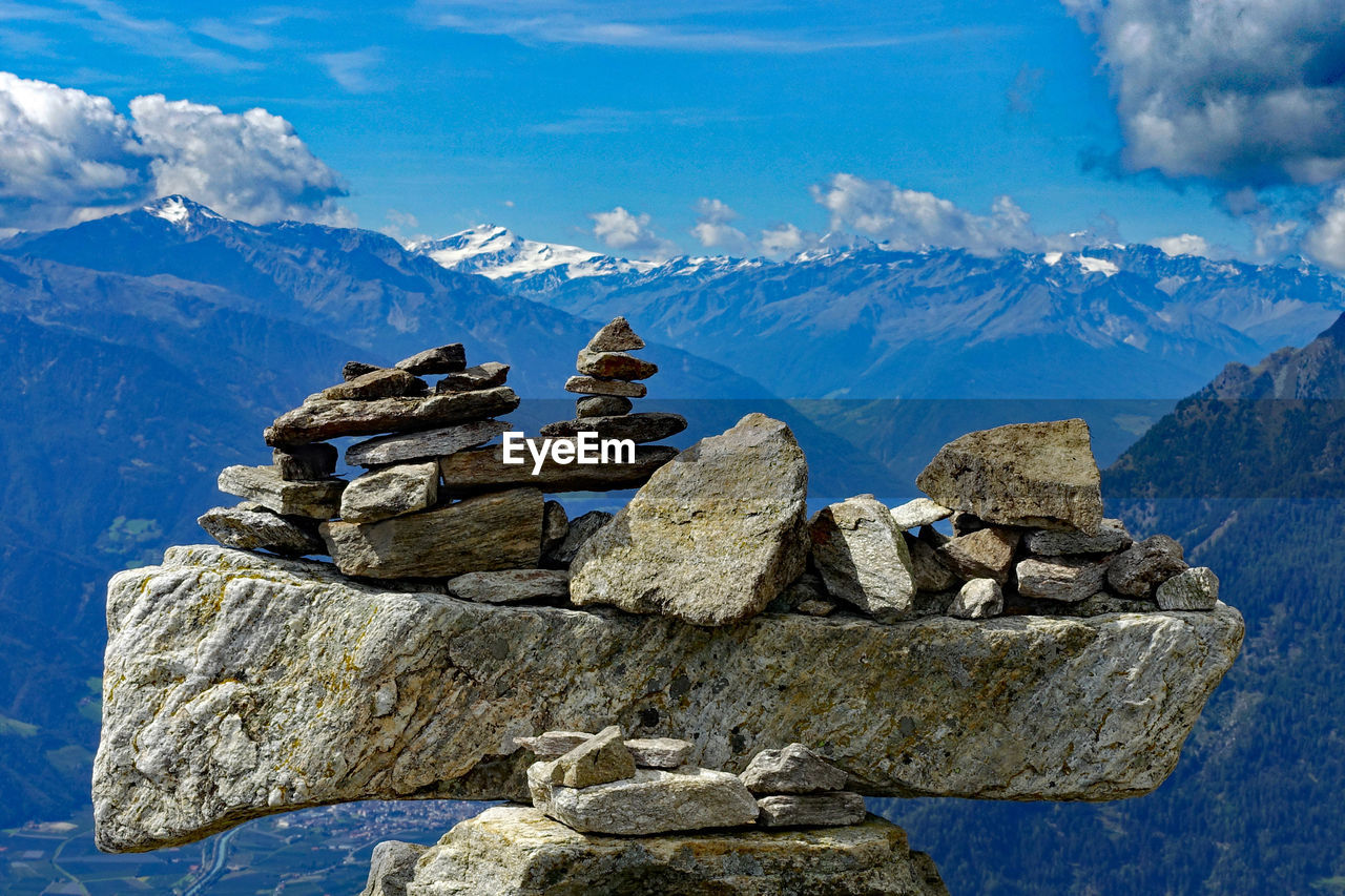 Stack of rocks against mountains