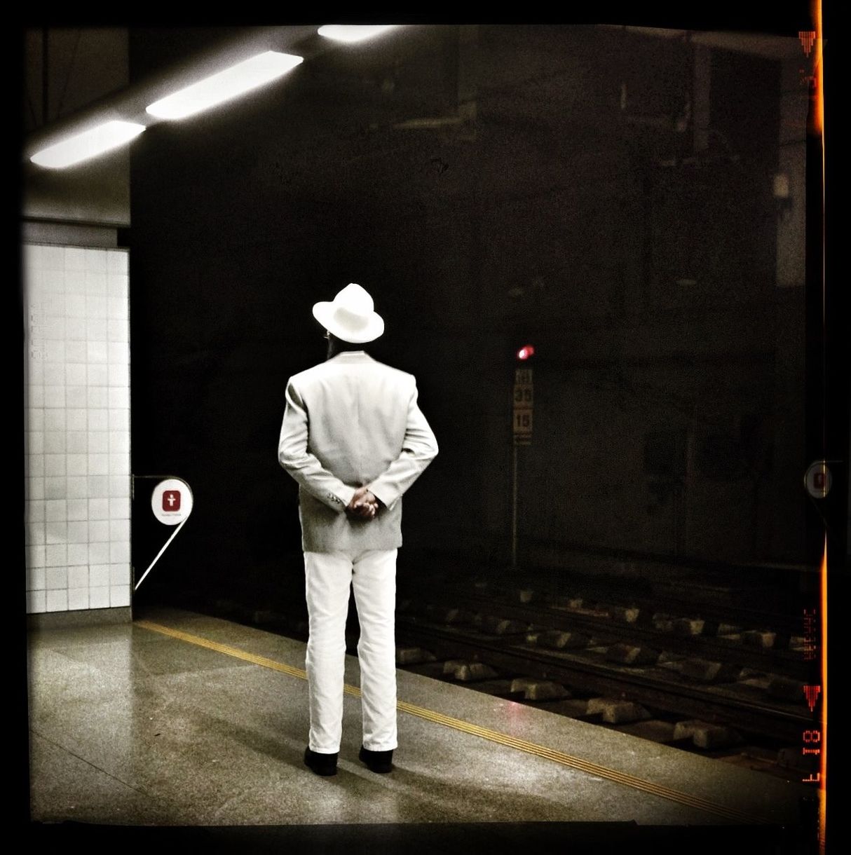Rear view of man waiting at subway station