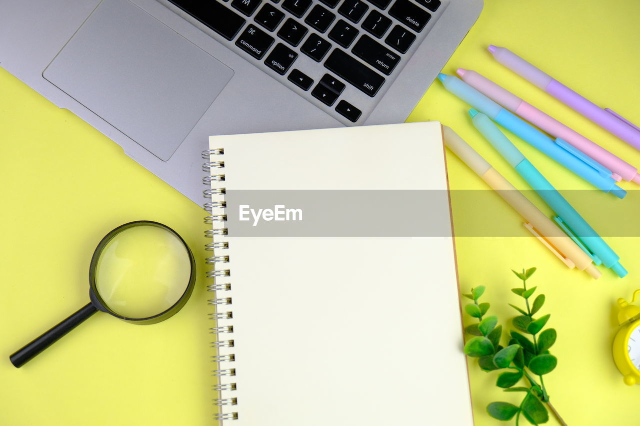 Home office workspace mockup with laptop, clipboard, notebook and accessories. flat lay, top view