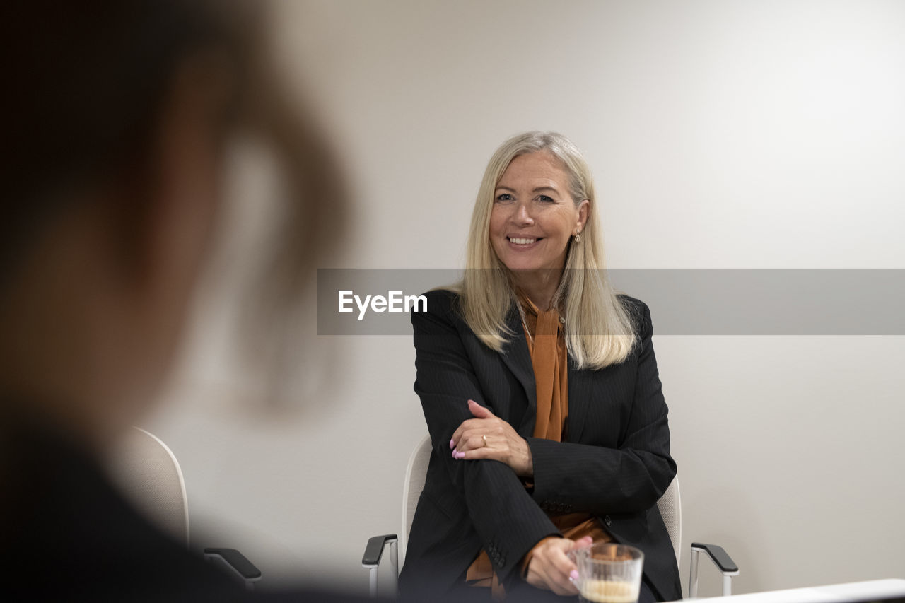 Smiling businesswoman looking away