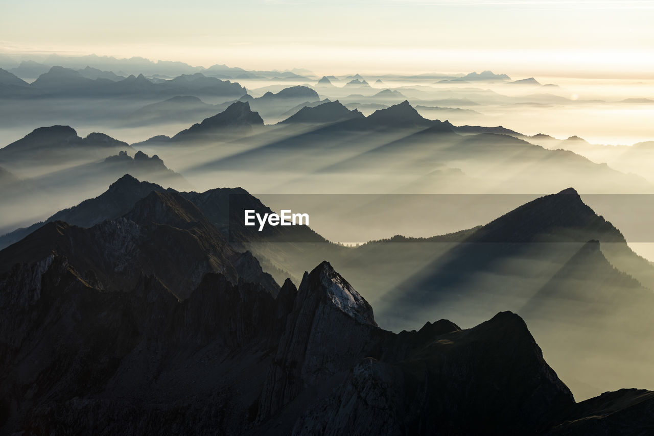 Scenic view of mountains against sky during sunrise