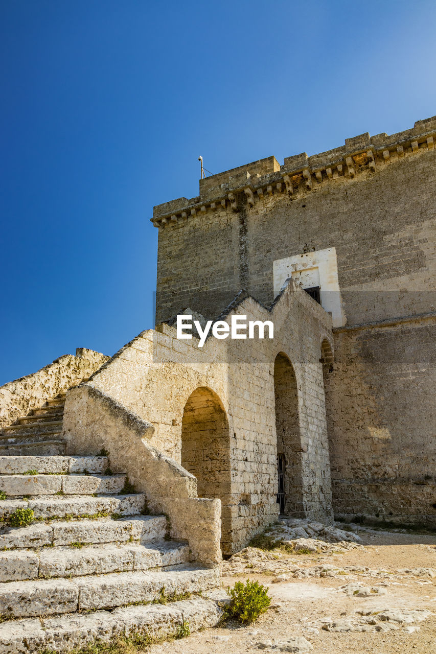 LOW ANGLE VIEW OF CASTLE AGAINST CLEAR BLUE SKY