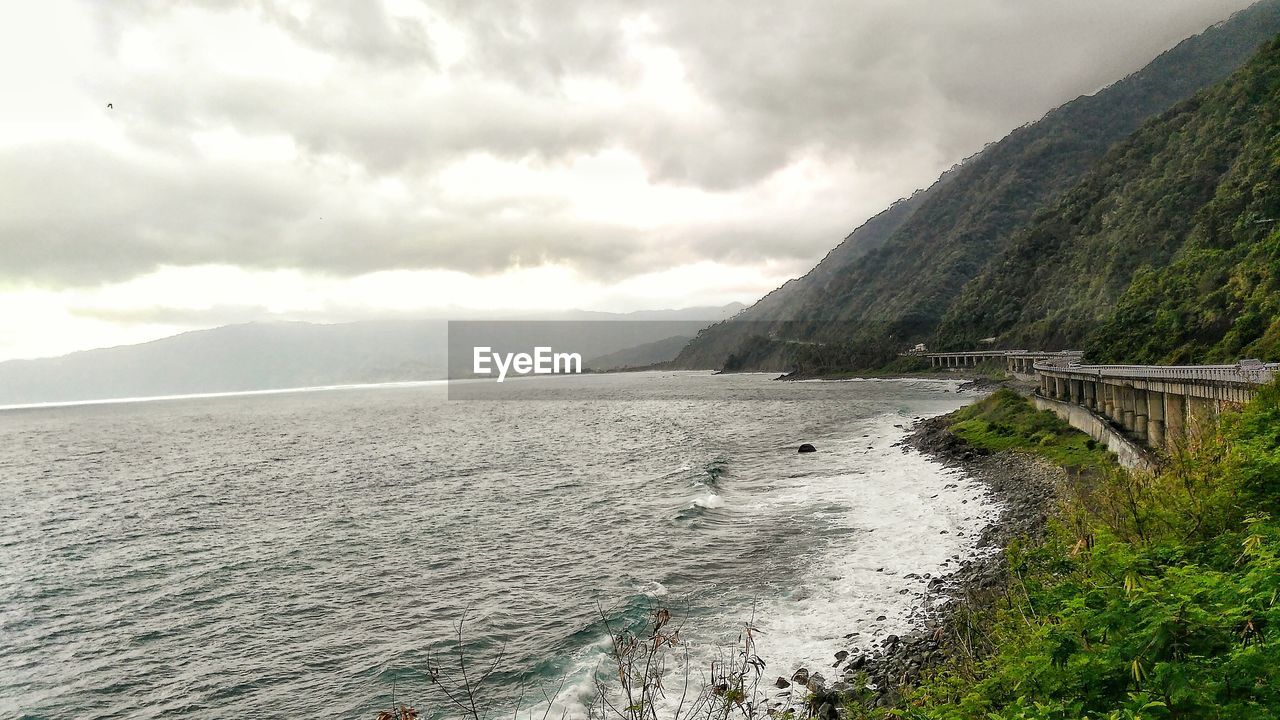 Scenic view of sea against cloudy sky