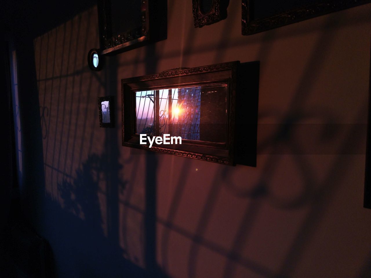 LOW ANGLE VIEW OF ILLUMINATED LIGHTING EQUIPMENT ON WALL AT NIGHT