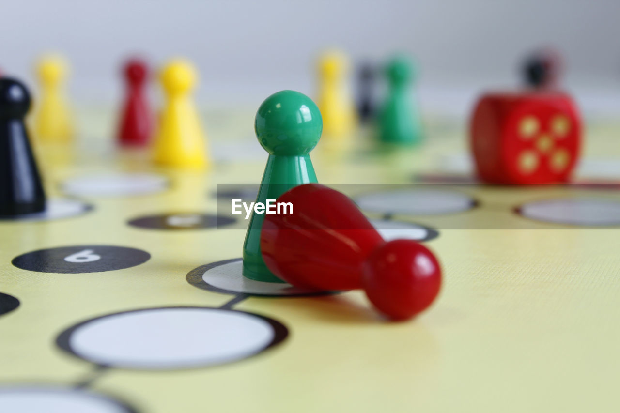 Close-up of multi colored play figures on boardgame table