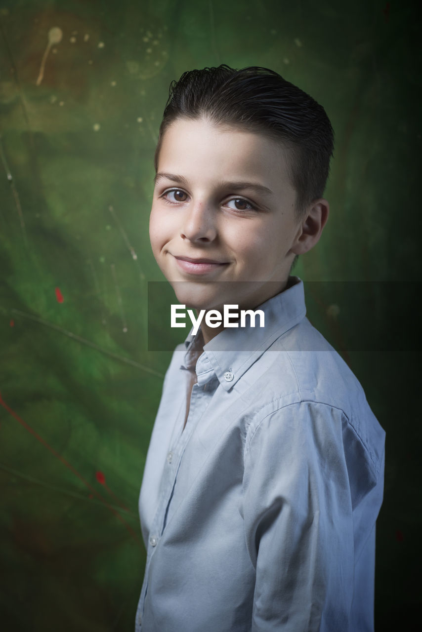 portrait of young man standing against blurred background