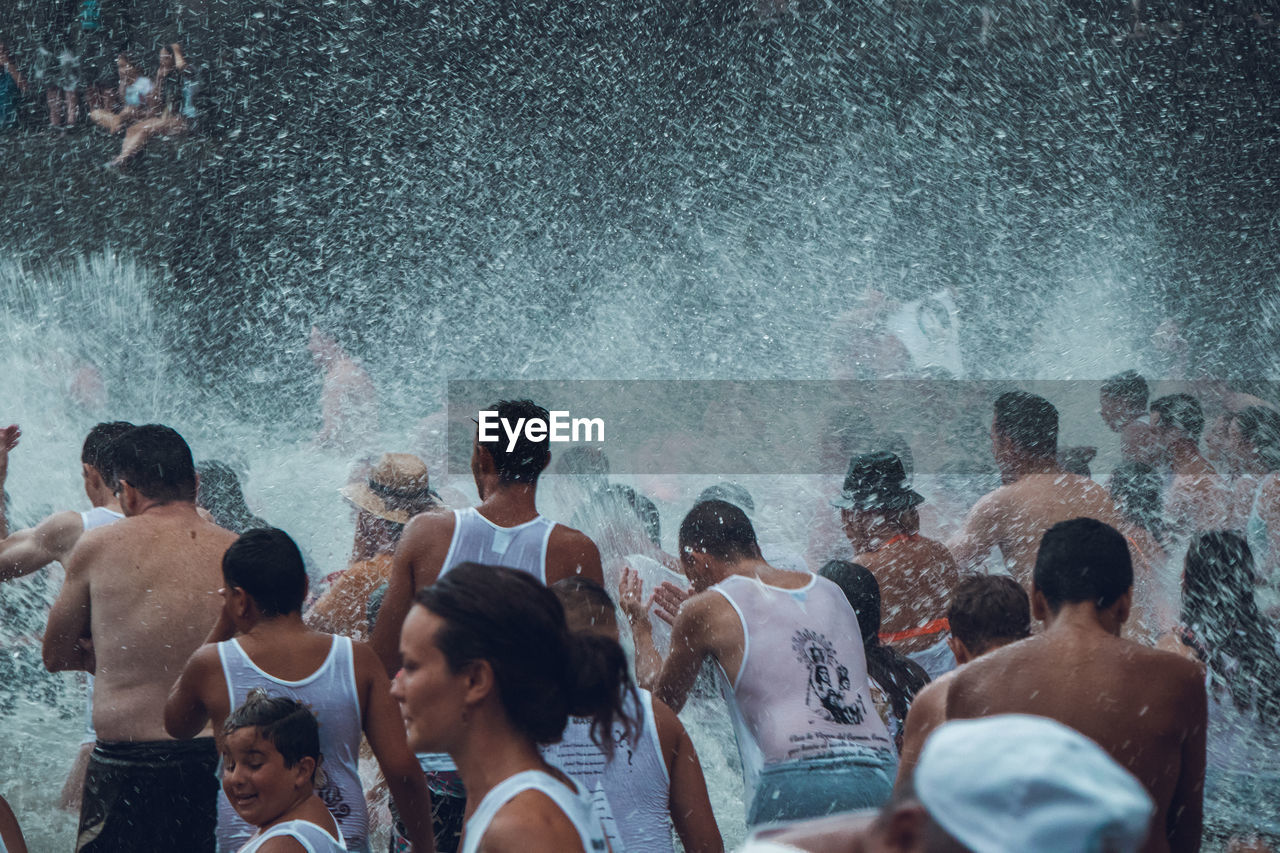 PEOPLE ENJOYING IN SWIMMING POOL AT SEA