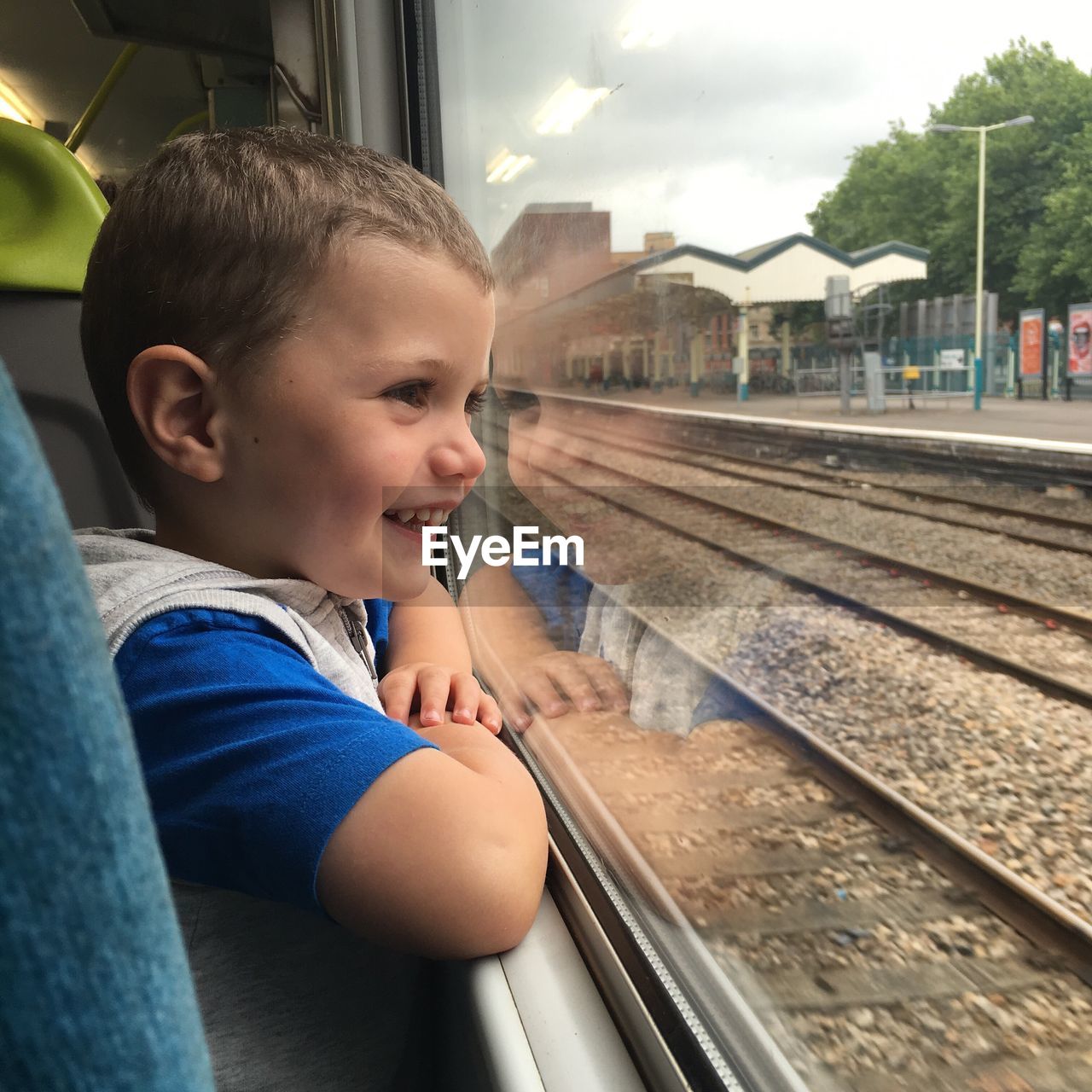 Close-up of boy looking at railroad track