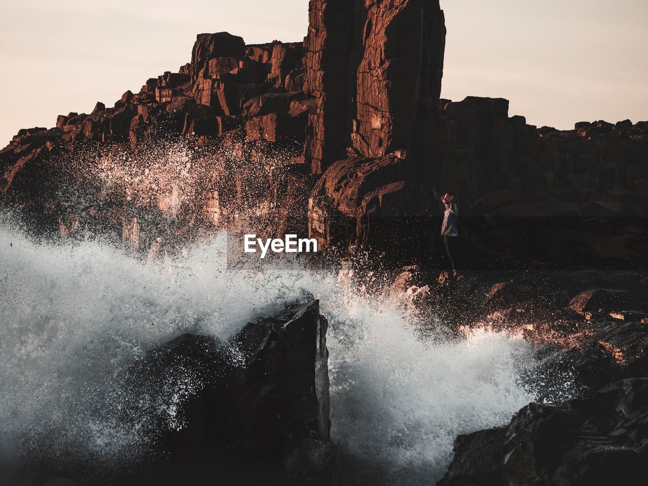 Waves splashing on at rocky shore