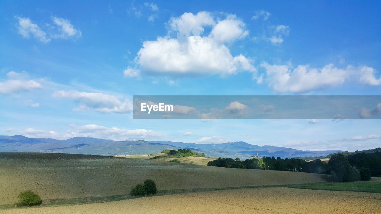 Scenic view of mountains against cloudy sky