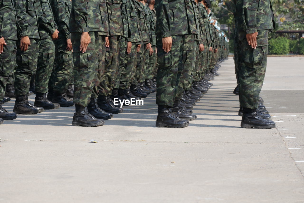 Low section of soldiers walking on street