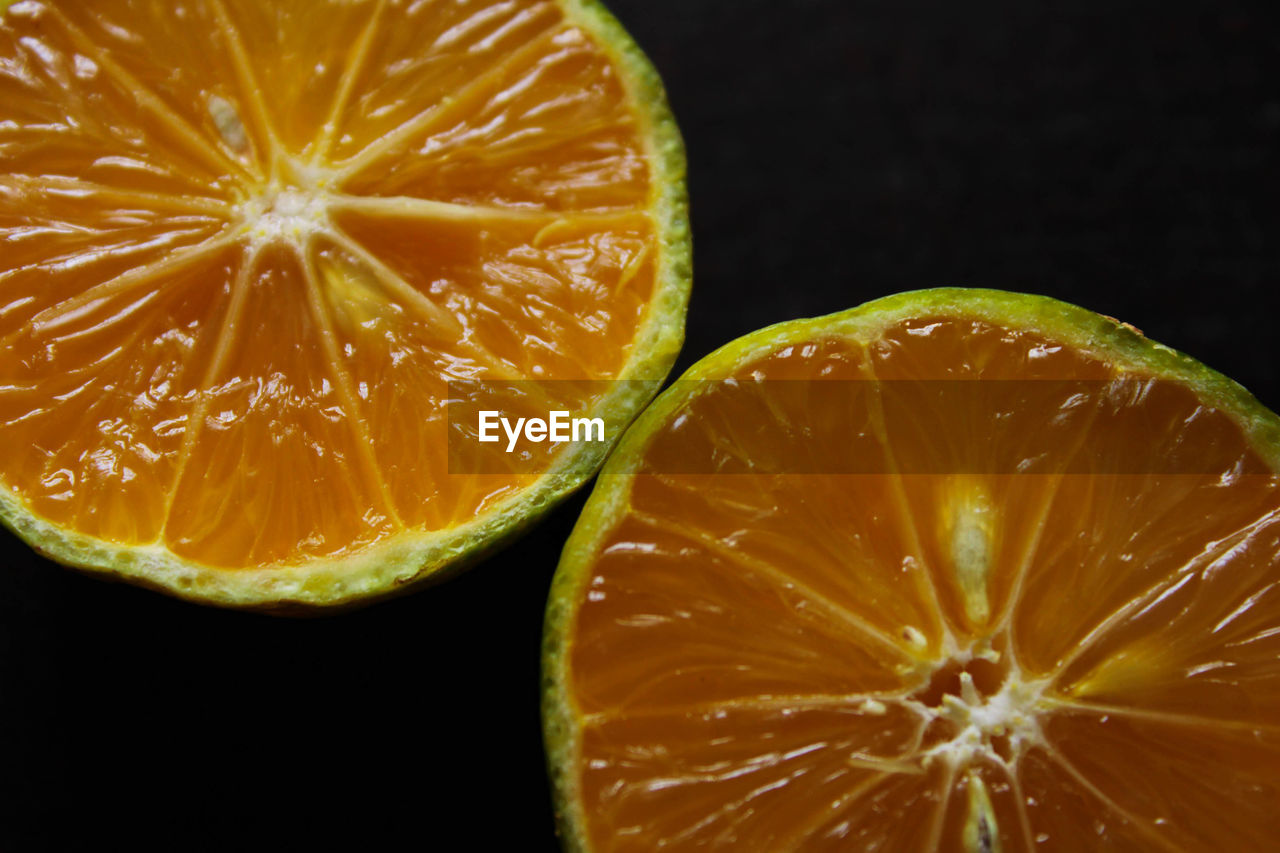 Directly above shot of oranges against black background