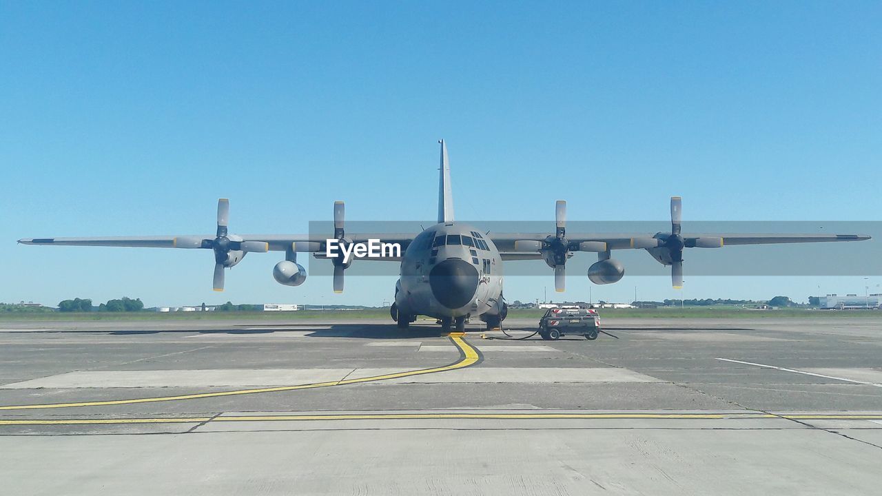 AIRPLANE ON RUNWAY AGAINST SKY