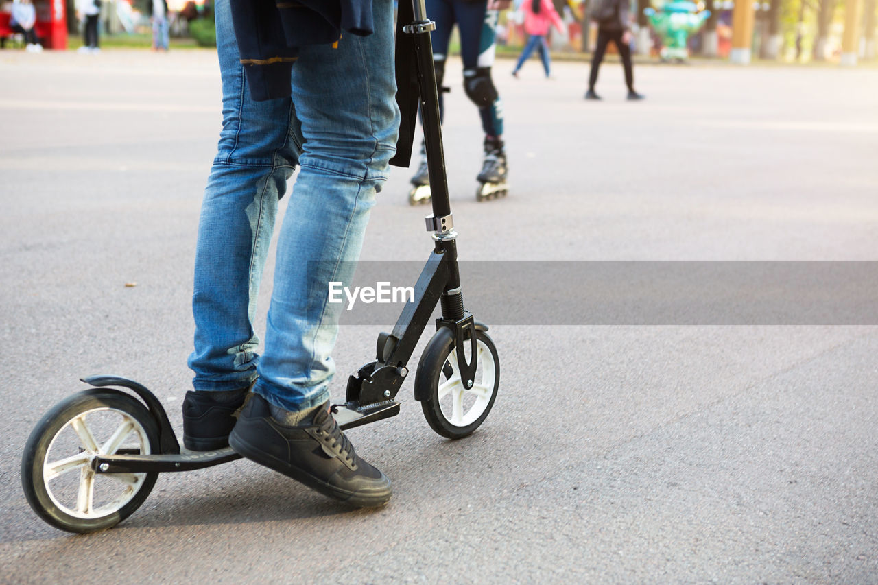 LOW SECTION OF PERSON RIDING BICYCLE ON STREET