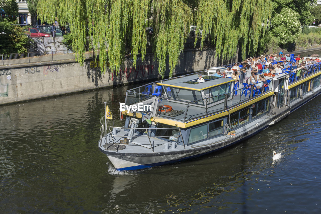 BOATS SAILING IN RIVER