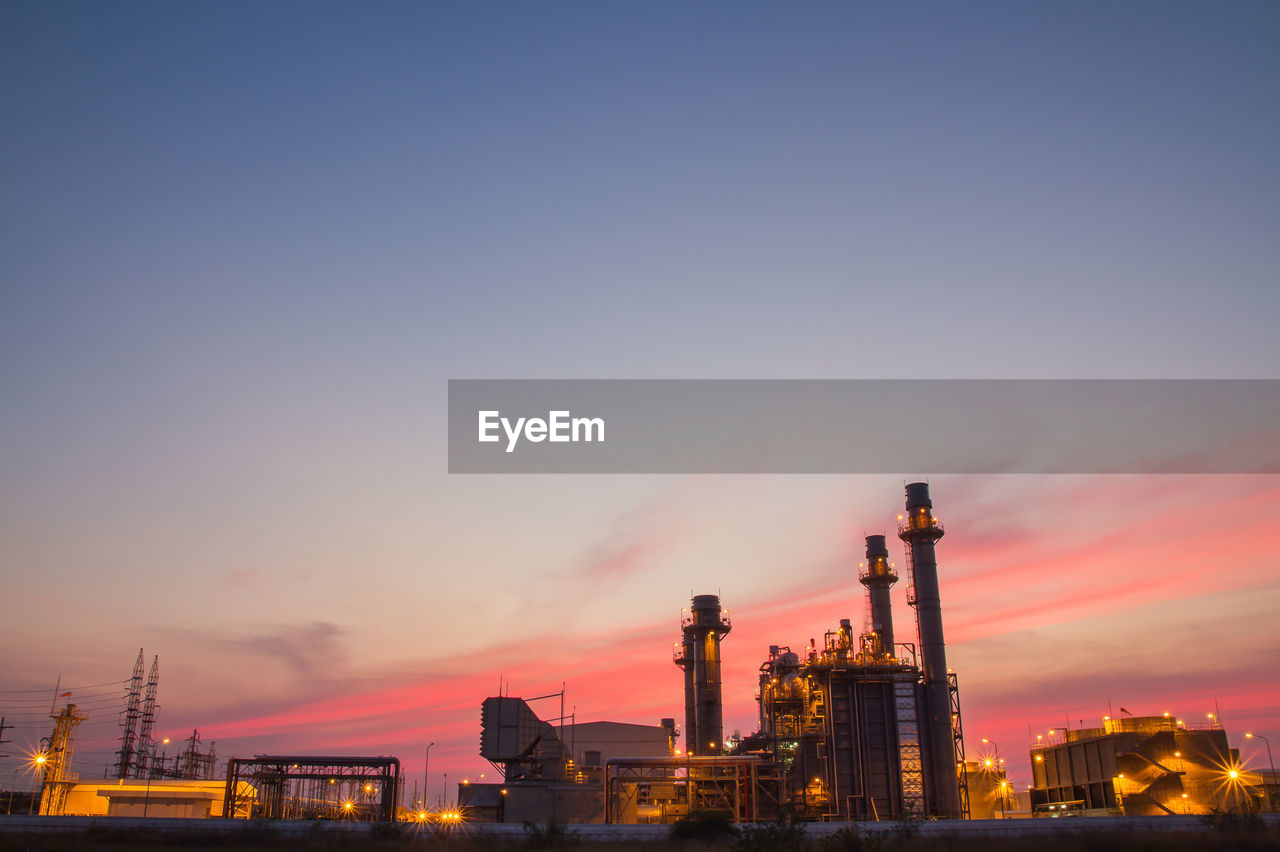 FACTORY AGAINST SKY AT SUNSET