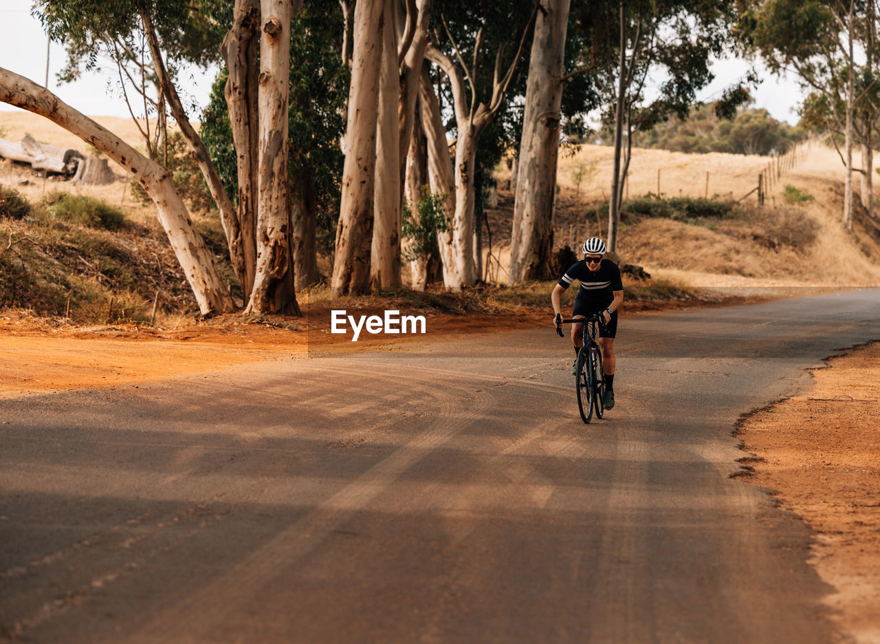 Man riding bicycle on road