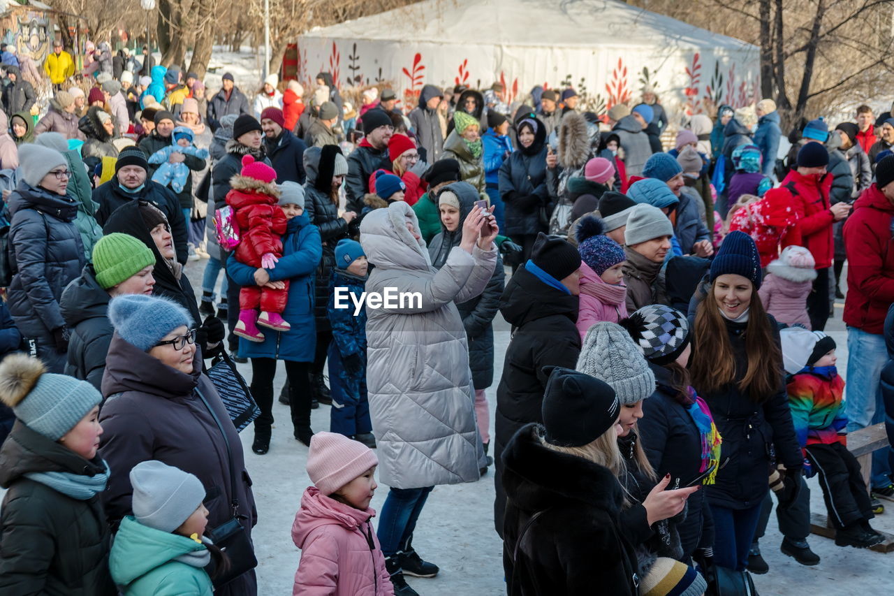 crowd, large group of people, group of people, men, social group, women, winter, adult, architecture, cold temperature, day, tree, sports, leisure activity, high angle view, outdoors, person, snow, enjoyment, nature, togetherness, lifestyles