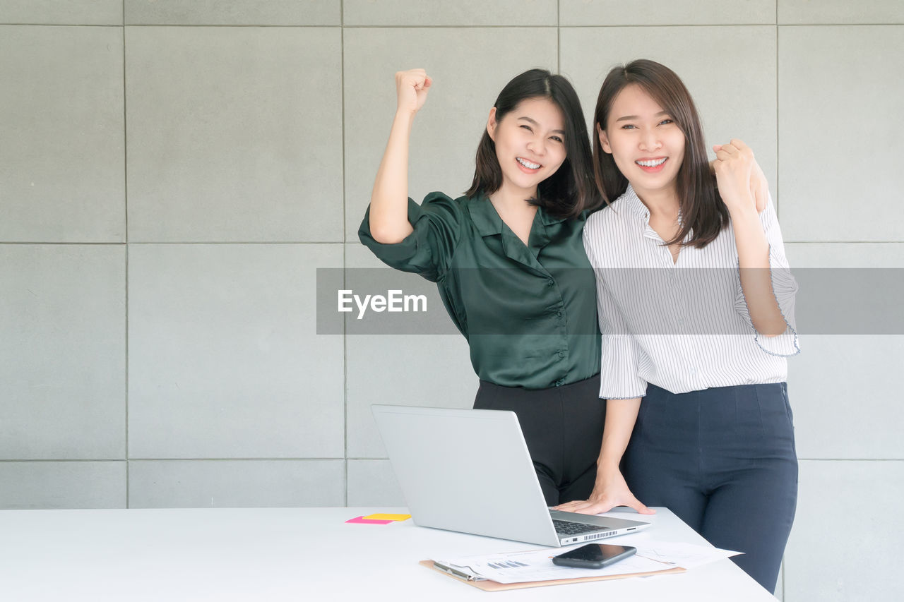 Portrait of a smiling young couple business employee enjoy and happy to work at company office