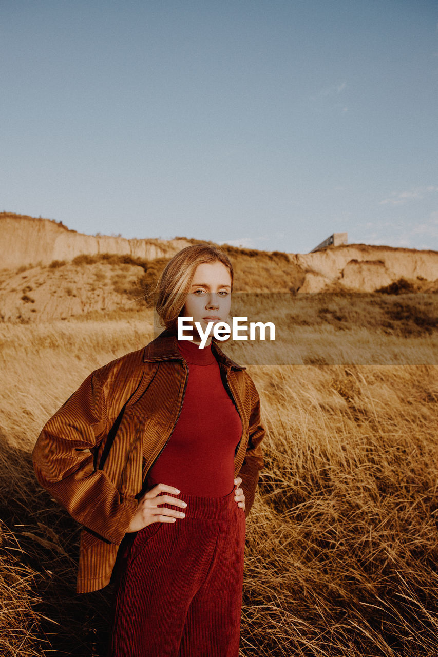 Portrait of woman standing on land against sky