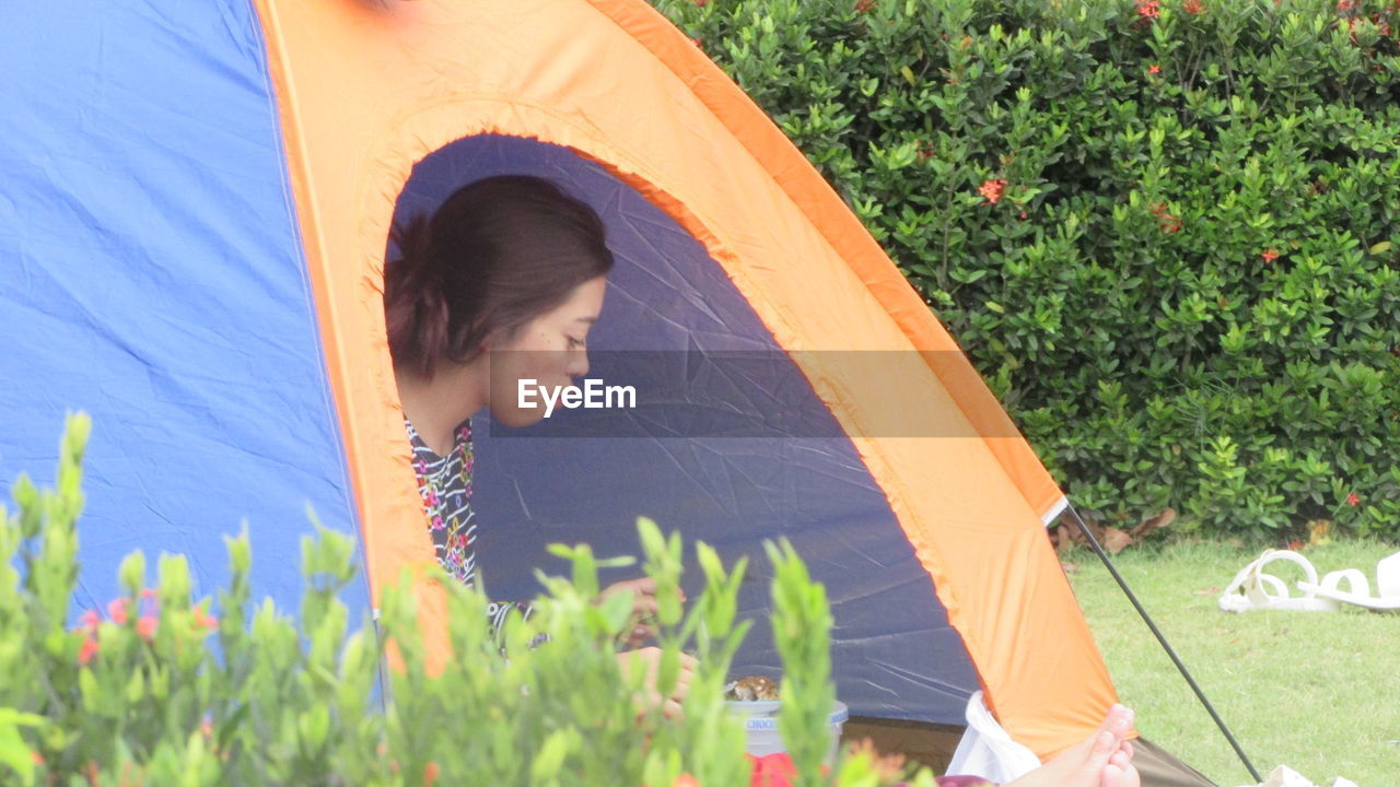 Woman inside tent at park