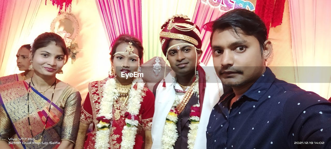 young adult, group of people, adult, event, portrait, clothing, indoors, celebration, togetherness, men, women, looking at camera, marriage, bride, smiling, emotion, happiness, traditional clothing, friendship, arts culture and entertainment, waist up, wedding reception, fun, multi colored, wedding, lifestyles, ceremony, person