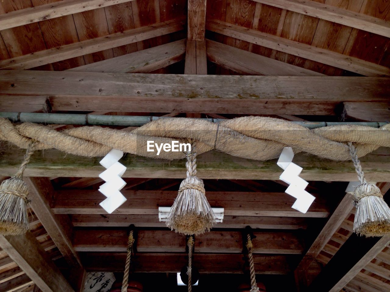 Low angle view of tassels hanging on roof beam