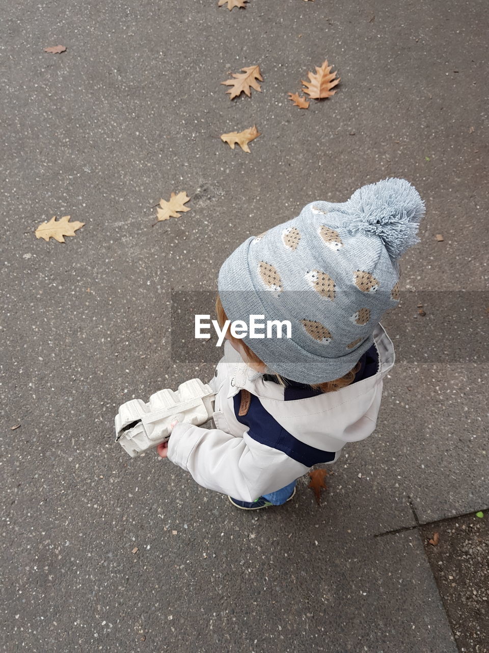 High angle view of baby standing on road