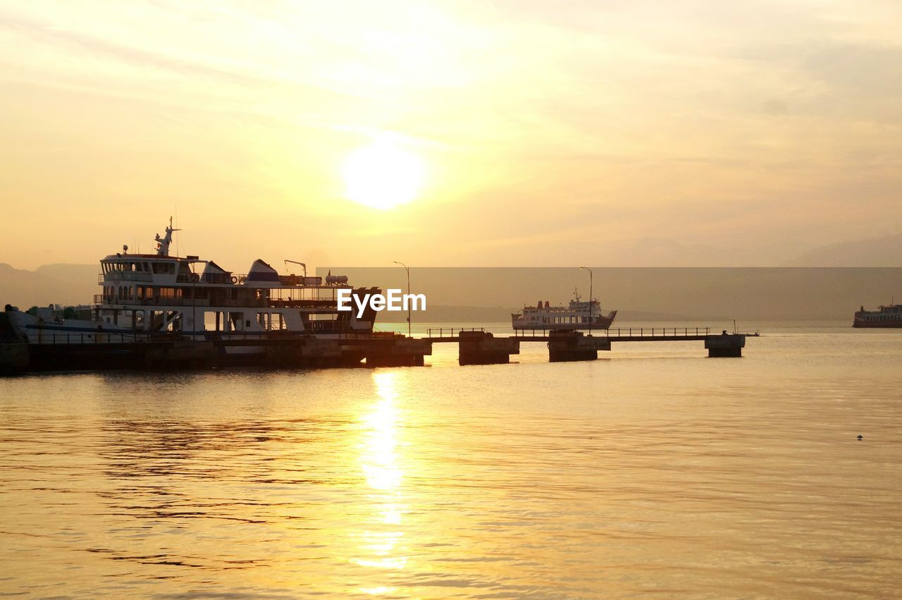 SHIP IN SEA AGAINST SKY AT SUNSET