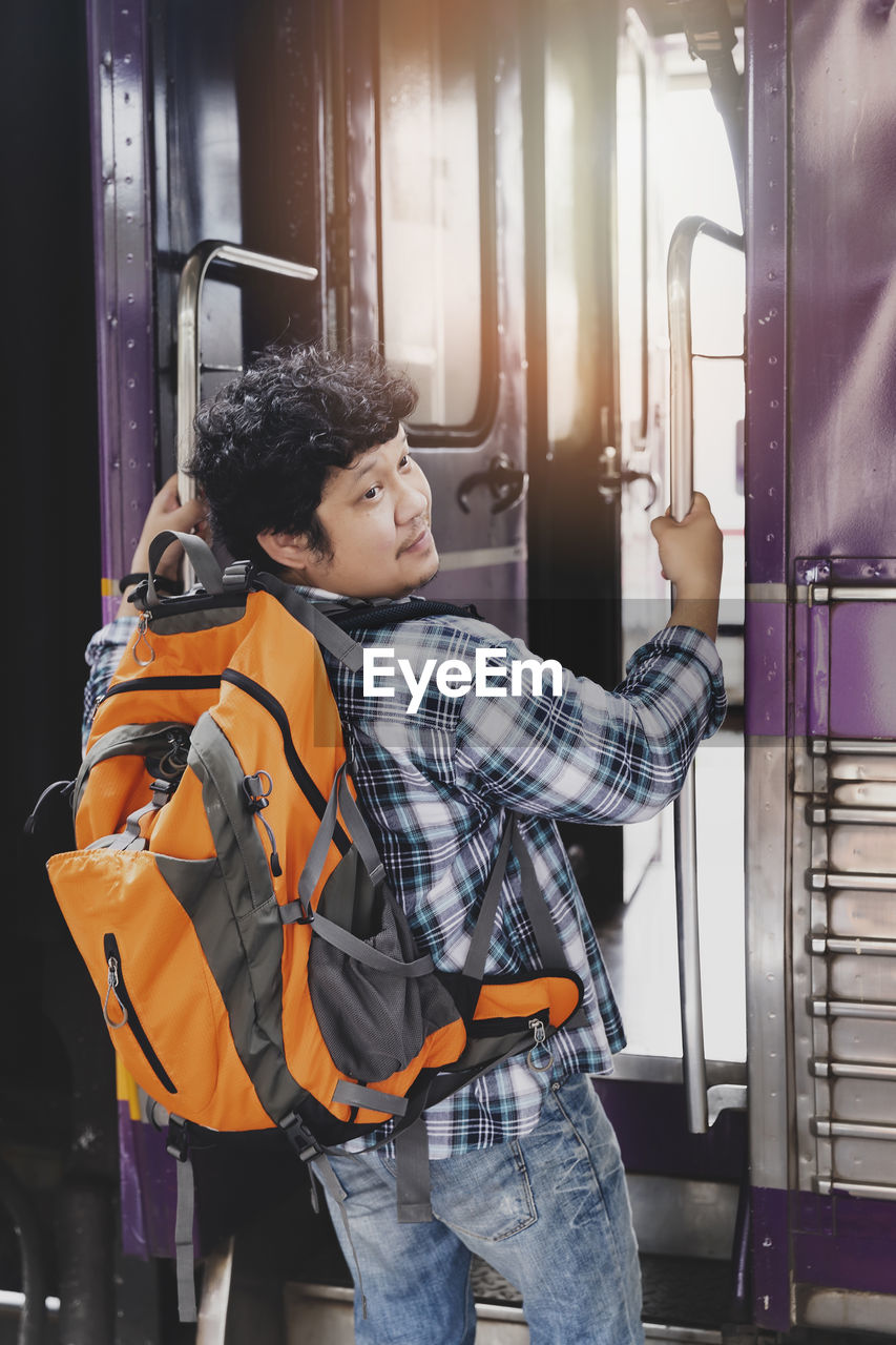 portrait of smiling young woman sitting in bus