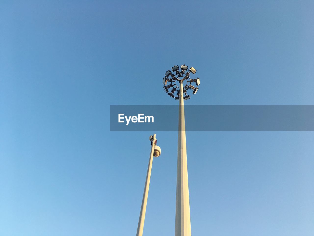 Low angle view of windmill against clear blue sky