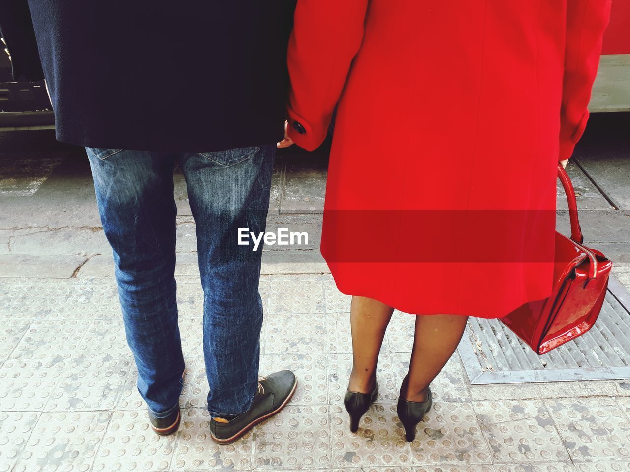 Low section of man and woman standing on road