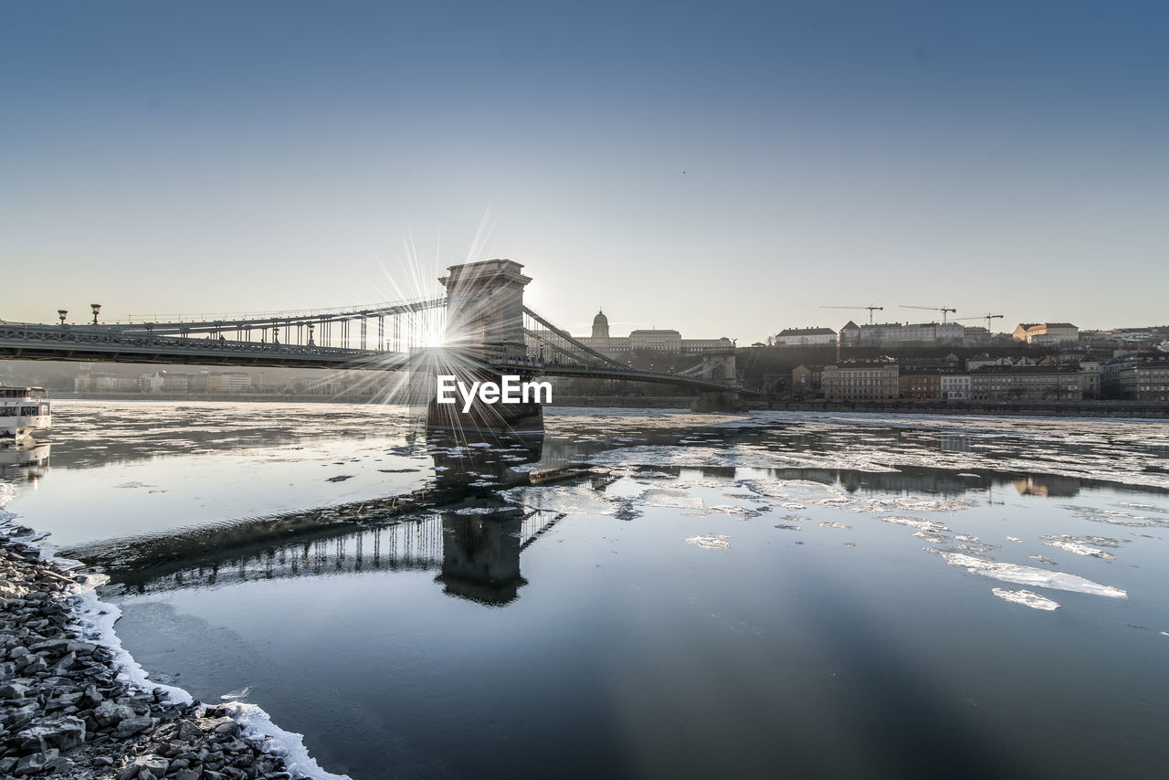 Scenic view of river against sky during winter