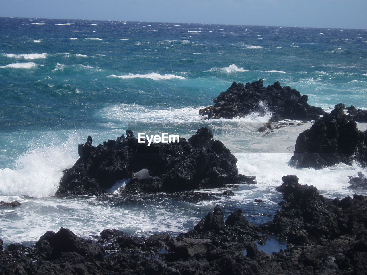 SCENIC VIEW OF ROCKS IN SEA AGAINST SKY