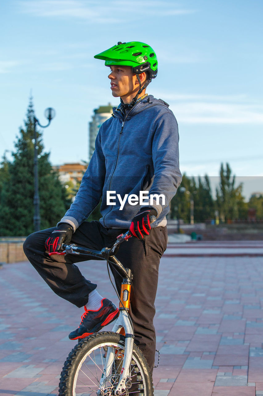 YOUNG MAN RIDING BICYCLE