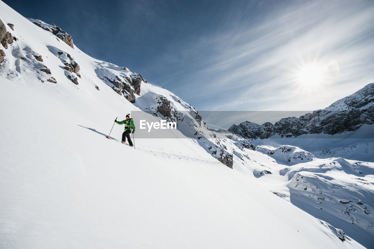 Man ski touring in alpine winter wonderland, arlberg, austria