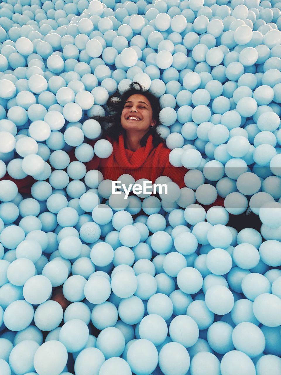 Smiling woman in ball pool