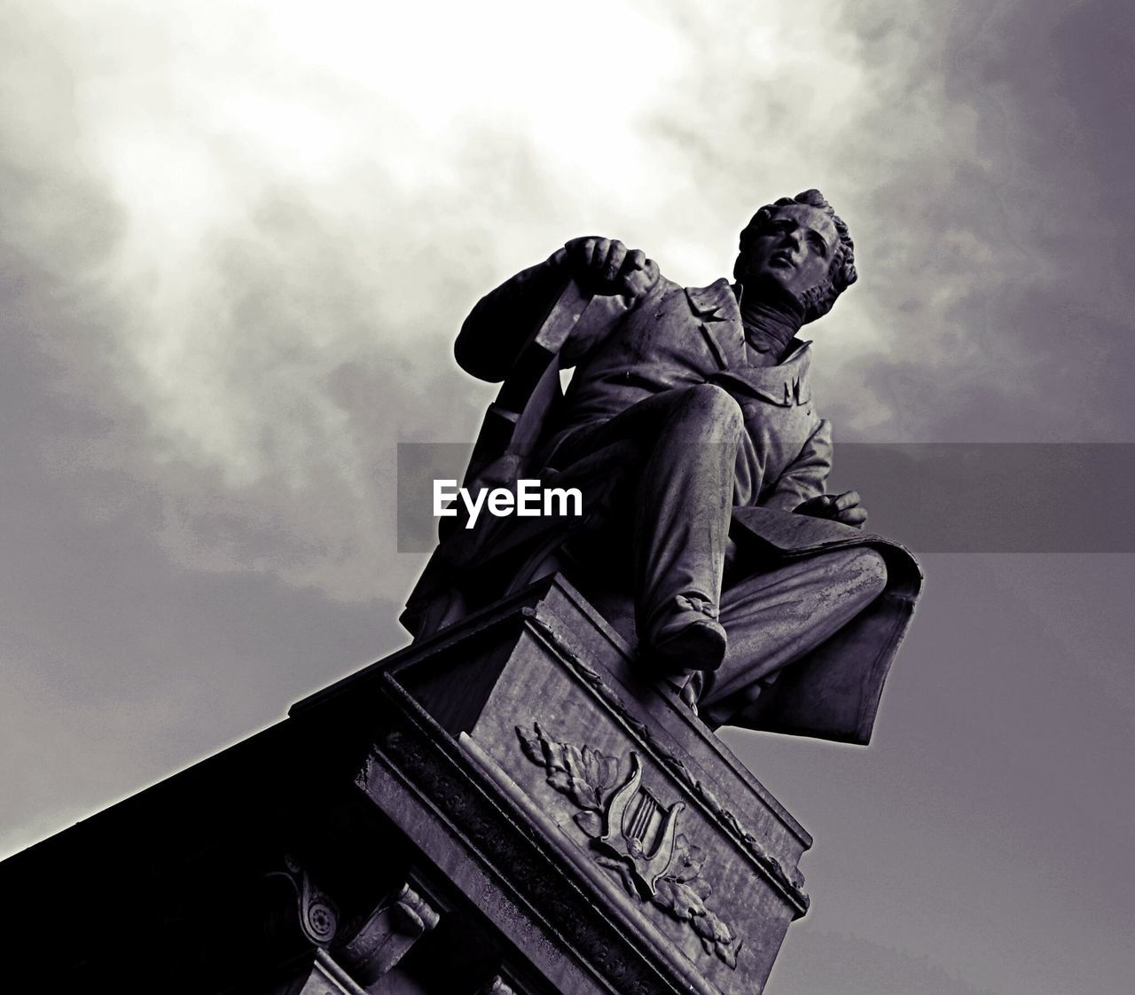 Low angle view of statue against cloudy sky