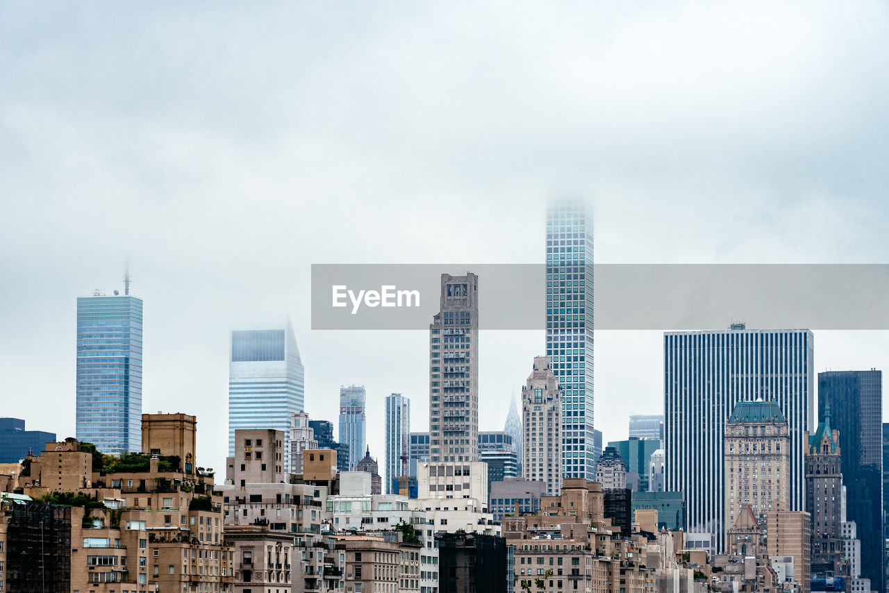 Modern buildings in city against sky