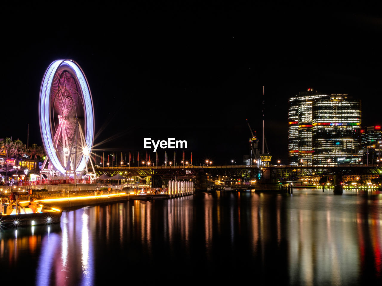 Extravagant lights of sydney darling harbour and its ferris wheel