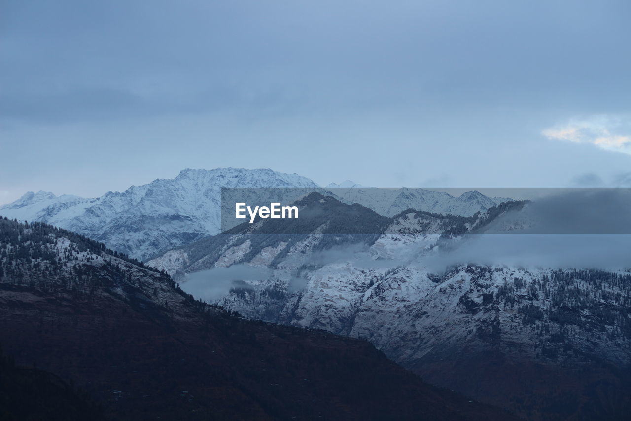 Scenic view of snowcapped mountains against sky