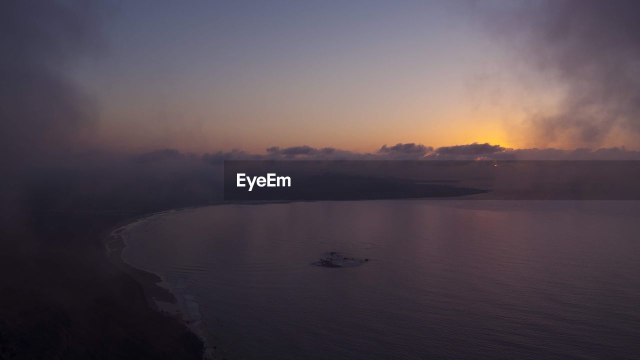 SCENIC VIEW OF SEA AT SUNSET