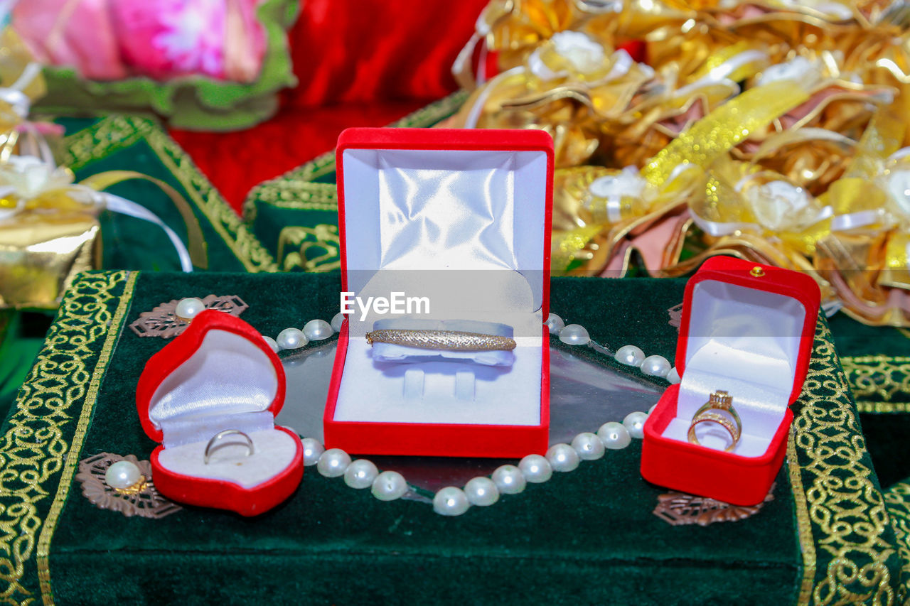 High angle view of wedding rings in boxes on book