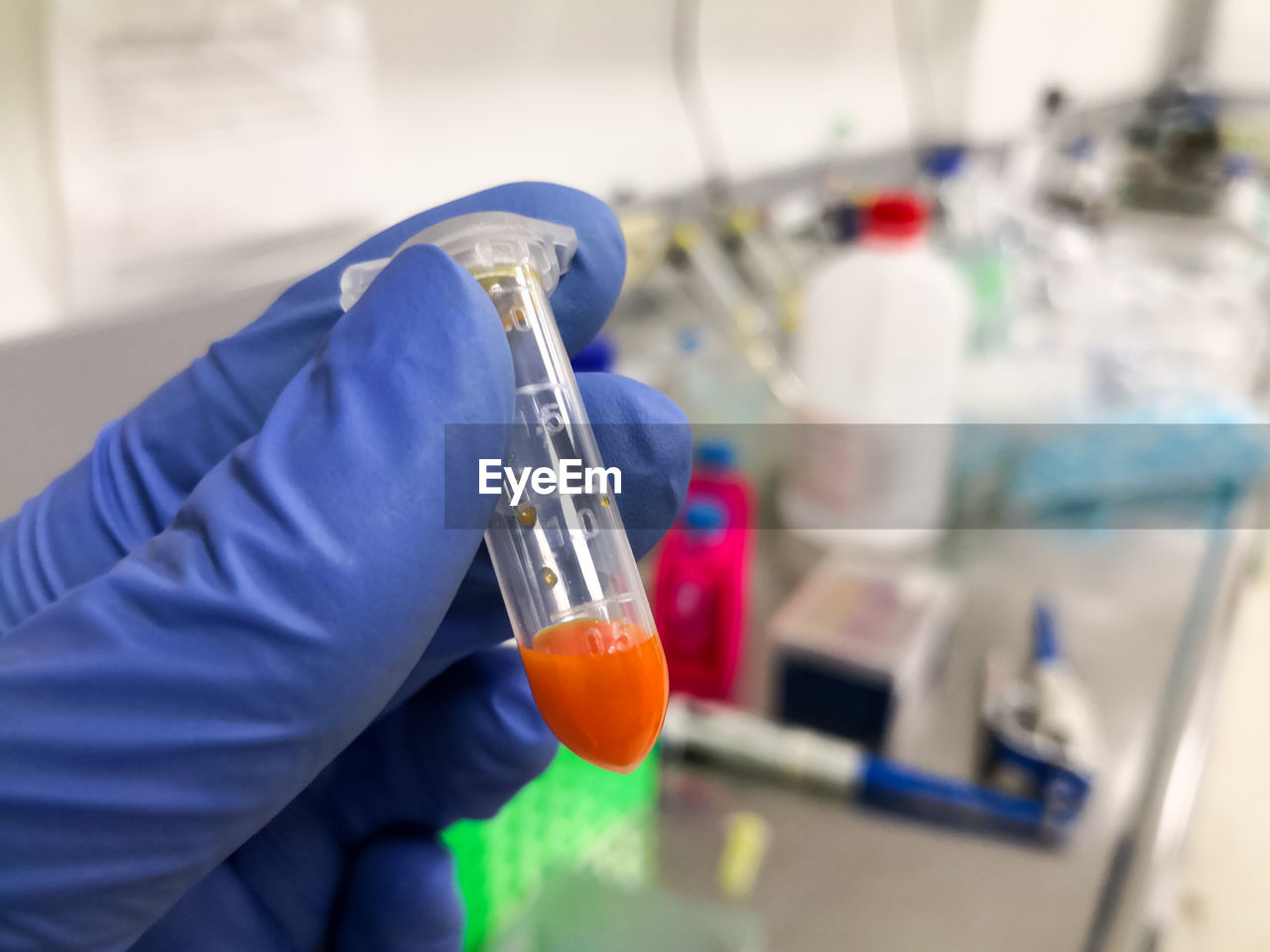 Cropped hand of scientist holding liquid in laboratory